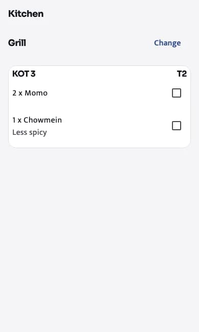 The kitchen view: KOT 3 for table T2 with 2 momo and 1 chowmein, less spicy, each with a tick box